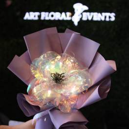 Iridescent flower wrapped in lavender paper