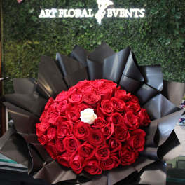 Large bouquet of red roses wrapped in black paper