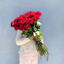 Large bouquet of red roses held by a person