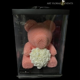 Pink pearl teddy bear holding a white rose heart in a display box