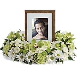 Framed photo surrounded by white and green flowers