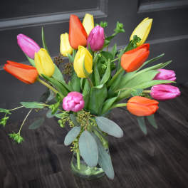 Bouquet of multicolored tulips in a glass vase