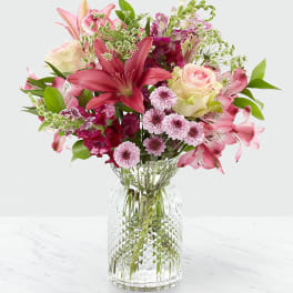 Pink and purple mixed bouquet in a clear glass vase