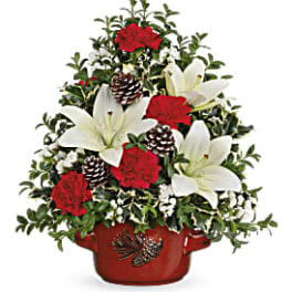Christmas arrangement with red carnations and white lilies in a red pot