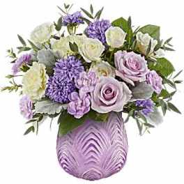 Lavender and white bouquet in a purple glass vase