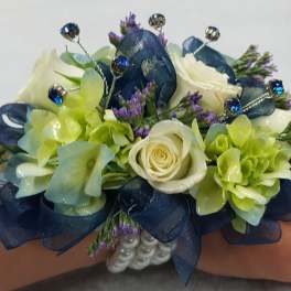 Blue and green wrist corsage with white roses and jeweled accents