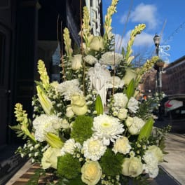 Tall white floral arrangement with roses, lilies, and chrysanthemums