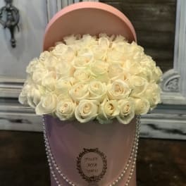 Cream rose bouquet in a pink hatbox with pearl trim