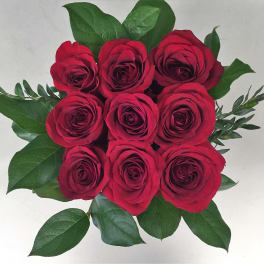 Bouquet of red roses with green leaves