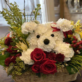 Basket arrangement with a teddy bear made of white carnations and red roses