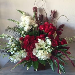 Red and white floral arrangement in a low container