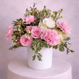 Pink and white rose bouquet in a white vase