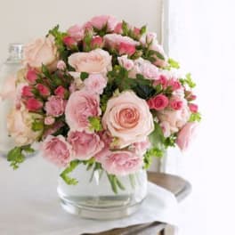 Pink and blush rose bouquet in a clear glass vase