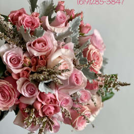 Pink rose bouquet with silver foliage and small filler flowers