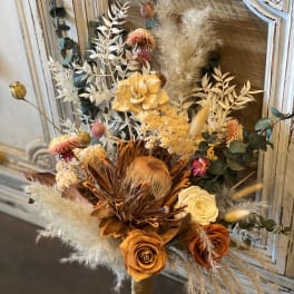 Dried bouquet with orange and cream roses and feathery pampas grass
