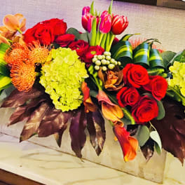 Colorful mixed floral arrangement in a rectangular container