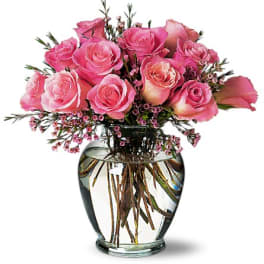 Pink roses arranged in a clear glass vase