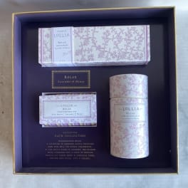 A boxed bath gift set with lavender-patterned soap and bath products.