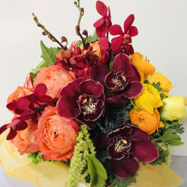 Bouquet of coral roses and burgundy orchids with yellow blooms
