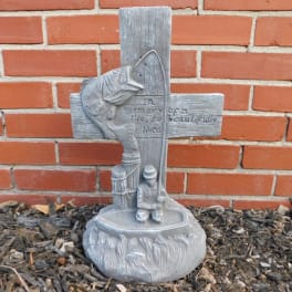 Gray memorial cross sculpture with a fish and kneeling figure
