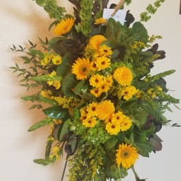 Tall yellow floral standing spray on an easel