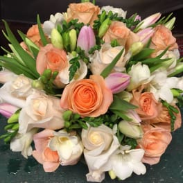 Bouquet of peach and white roses with pink tulips