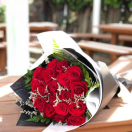 Bouquet of red roses wrapped in black and white paper
