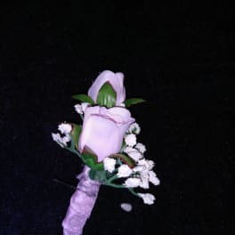 Small lavender rose boutonniere with white filler flowers
