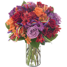 Mixed bouquet of roses and alstroemeria in a clear glass vase