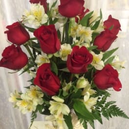 Bouquet of red roses and white alstroemeria in a clear vase