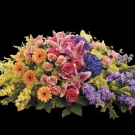 Mixed bouquet with pink lilies, roses, gerbera daisies, and purple blooms