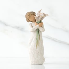 Small figurine of a girl holding white flowers