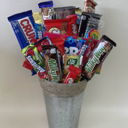 Assorted candy bars arranged in a galvanized metal bucket