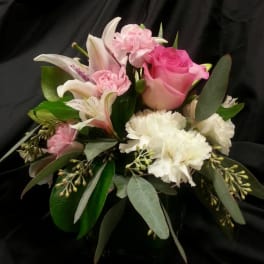 Pink roses and white lilies with carnations in a bouquet