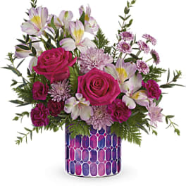 Pink roses and pale lilies in a patterned vase