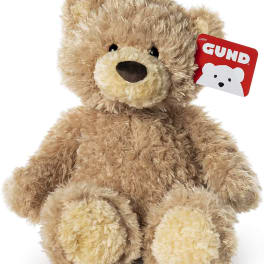 Plush teddy bear with a red GUND tag