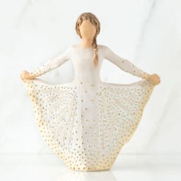Decorative figurine of a girl in a white dress with gold dots