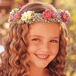 Girl wearing a floral crown with pink and purple flowers