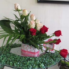 Bouquet of red and white roses in a heart-patterned box