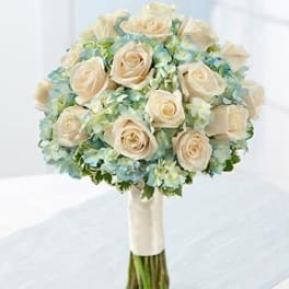 Cream rose bouquet with pale blue flowers and wrapped stems
