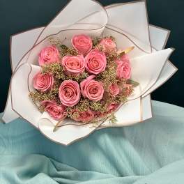 Bouquet of pink roses wrapped in white paper