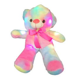 Large rainbow plush teddy bear with glowing lights and pink bow