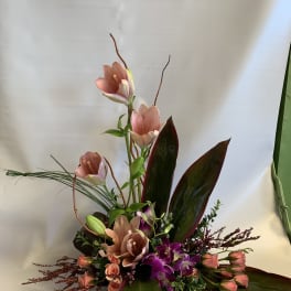 Tall floral arrangement with pink blooms and purple orchids