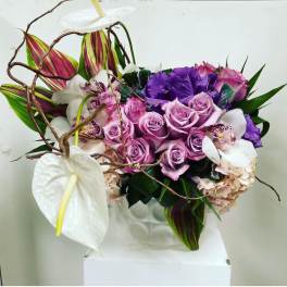 Bouquet of lavender roses, white anthuriums, and purple flowers