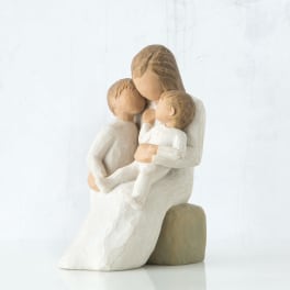 Wooden figurine of a seated woman holding two children