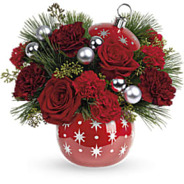 Red roses and carnations in a red ornament vase with silver balls