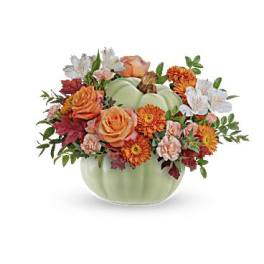 Autumn floral arrangement in a pale green pumpkin vase