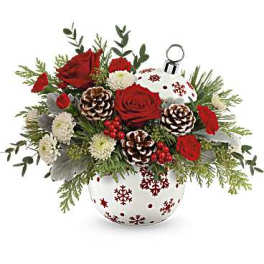 Red roses and white flowers in a snowflake vase with pinecones