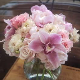 Pink and white bouquet in a clear glass vase