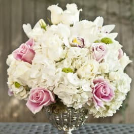 Pink and white rose bouquet in a silver vase